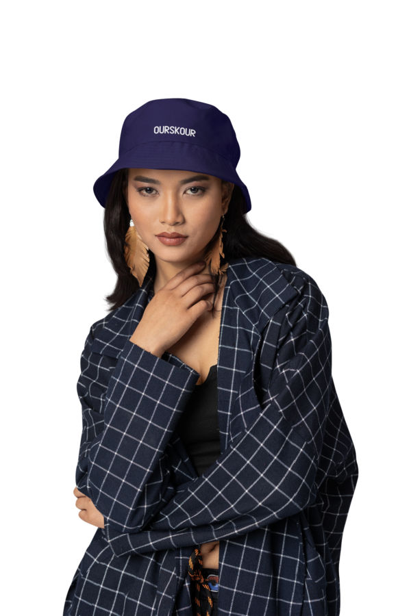 A MODEL WEARING A OURSKOUR BUCKET HAT